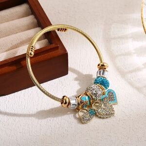 Elegant Gold Bracelet with Turquoise and Silver Charms